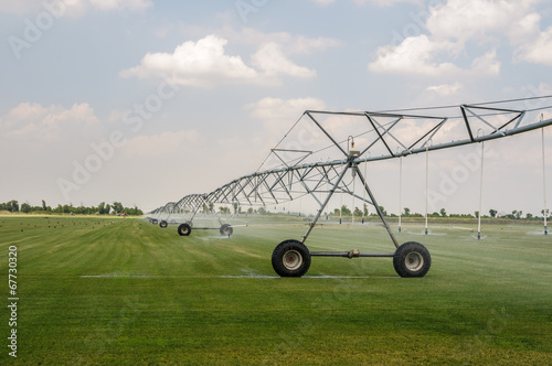 Self-propelled sprinkler installation waters mowed lawn