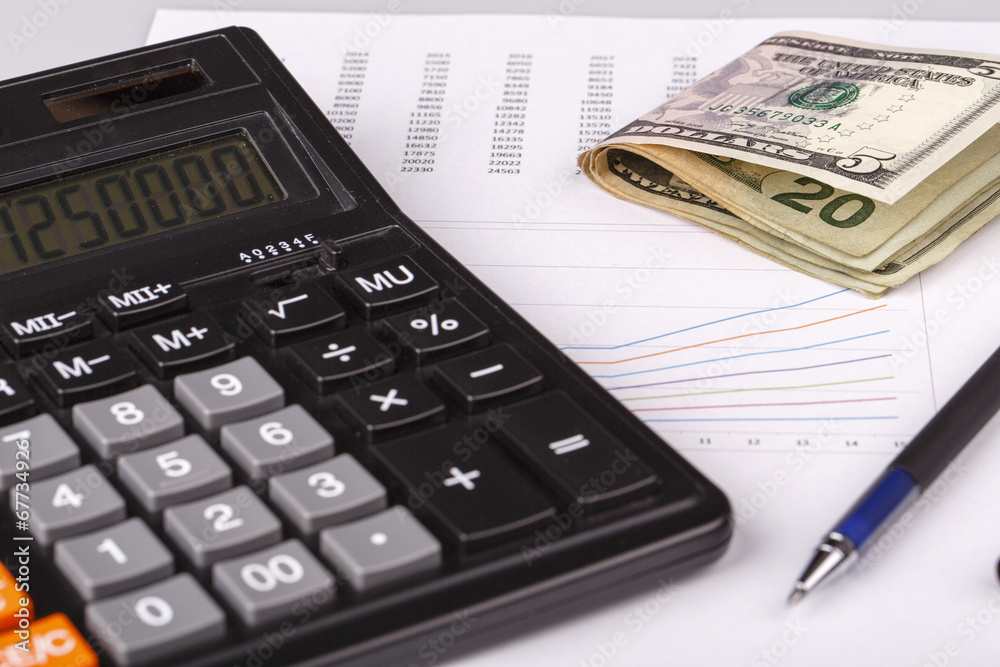 Business Charts with calculator, money and pen Business Charts with calculator, money and pen