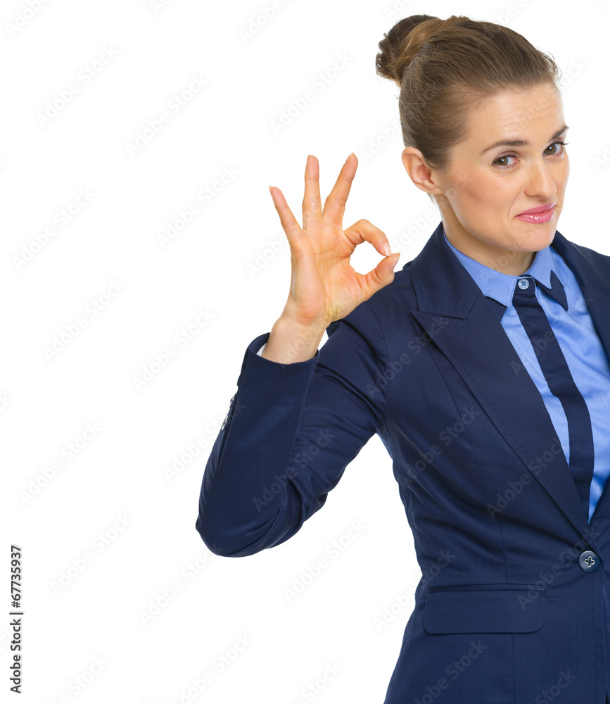 Smiling business woman showing ok gesture