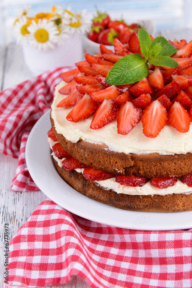 Delicious biscuit cake with strawberries on table close-up Delicious biscuit cake with strawberries on table close-up