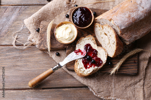 Fresh bread with homemade butter and blackcurrant jam