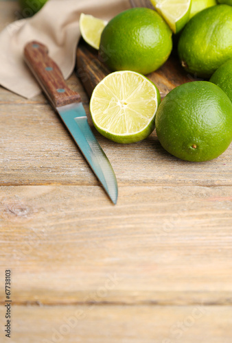 Fresh juicy limes on old wooden background