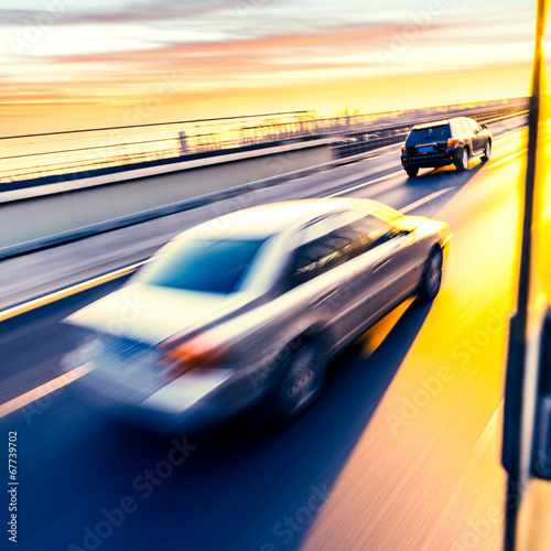 Car driving on freeway at sunset  motion blur