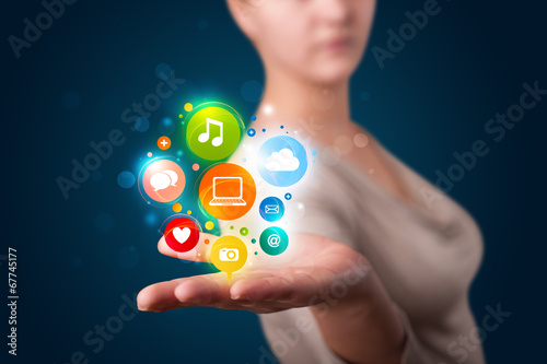 Wallpaper Mural Young woman presenting colorful technology icons and symbols Torontodigital.ca