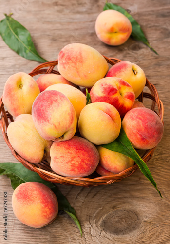 Ripe peaches in a wicker basket