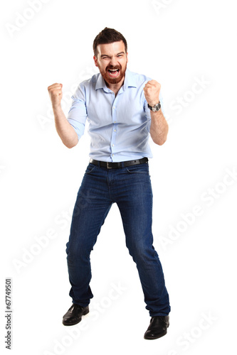 Excited handsome man with arms raised in success -