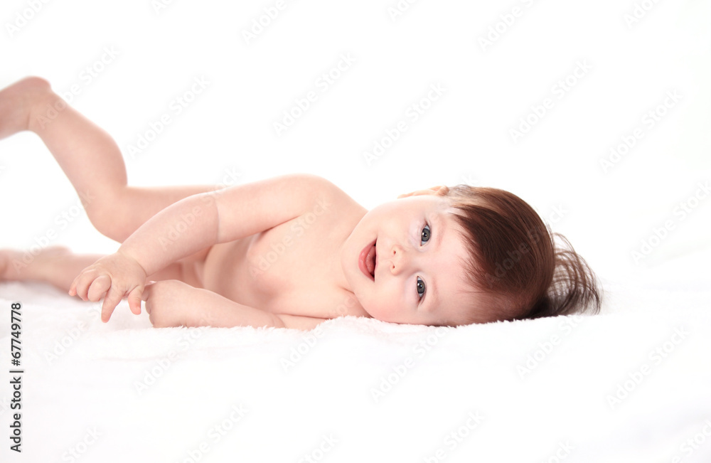 Happy little baby smiling while lying in bed Happy little baby smiling while lying in bed