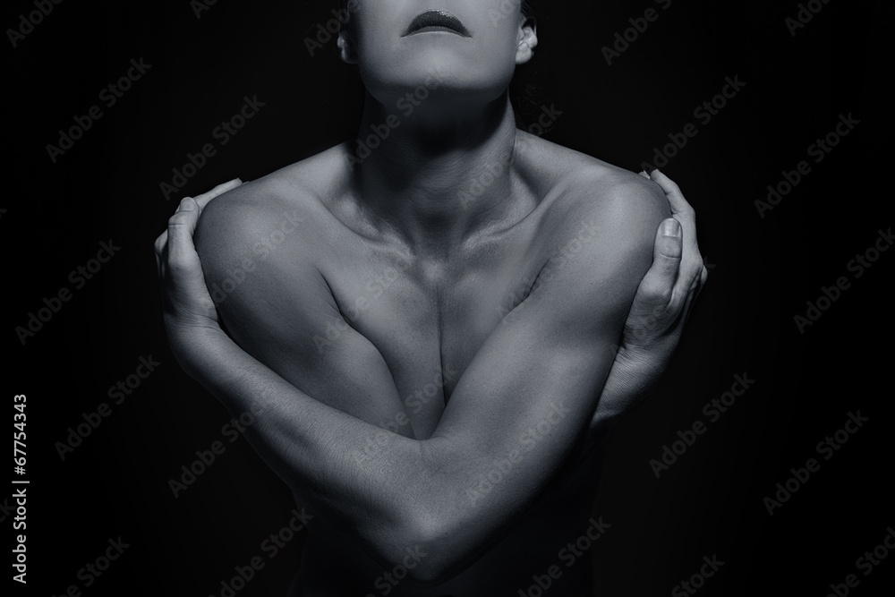 Body scape of woman front with arms crossed in low light emotion Body scape of woman front with arms crossed in low light emotion