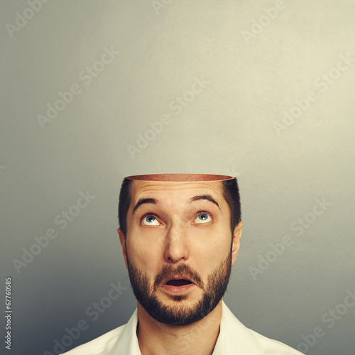 surprised man looking up at his open empty head photo