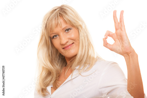 Mature woman showing ok sign hand gesture isolated