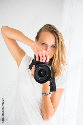 Pretty, female photographer with digital camera