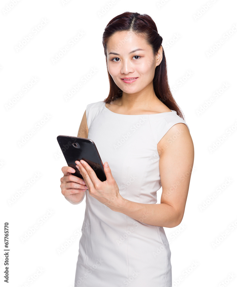 Asian woman reading from tablet on white background Asian woman reading from tablet on white background