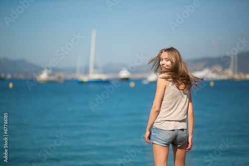 Young girl enjoying her vacation by the sea