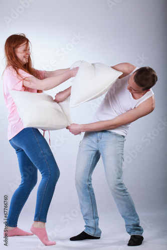 Teenagers fighting with pillows