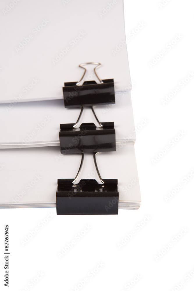 Binder clips with black white paper over white background