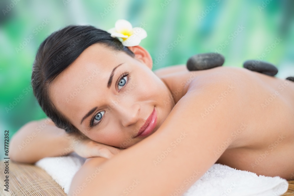 Beautiful brunette enjoying a hot stone massage Beautiful brunette enjoying a hot stone massage