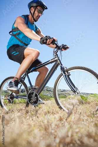 Fototapeta Naklejka Na Ścianę i Meble -  Fit cyclist riding in the countryside