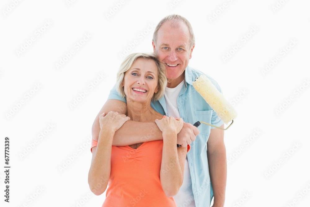 Happy older couple holding paint roller Happy older couple holding paint roller