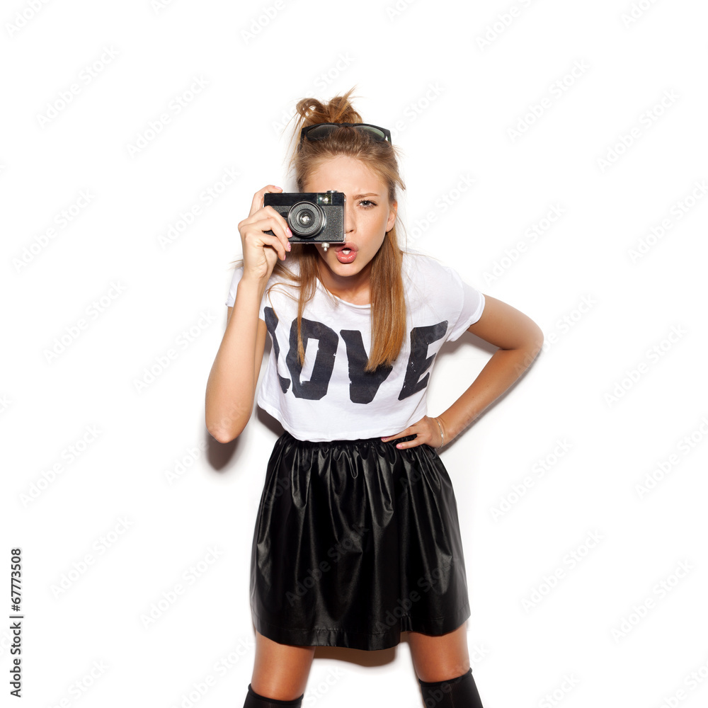 Young woman making photo using noname retro camera