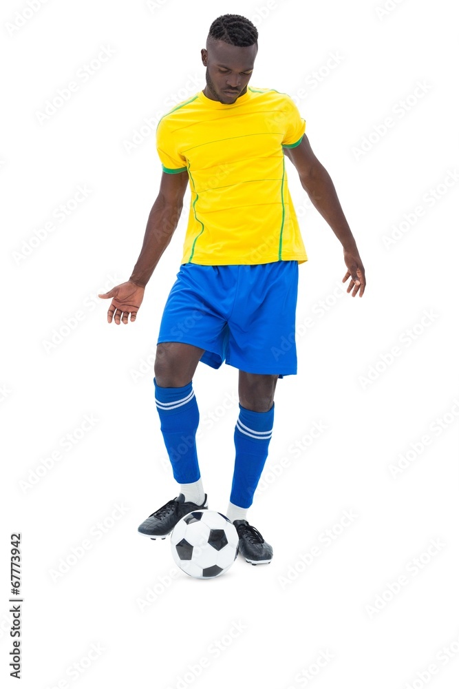 Football player in yellow kicking ball