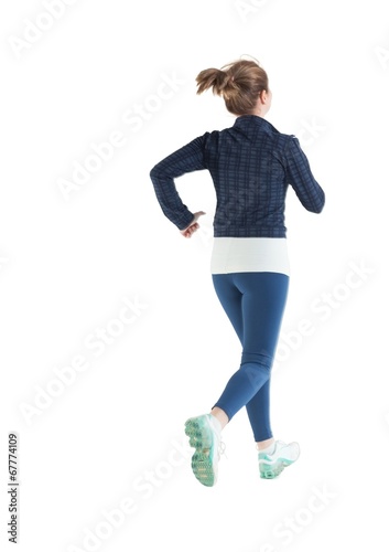 Rear view of a young woman running