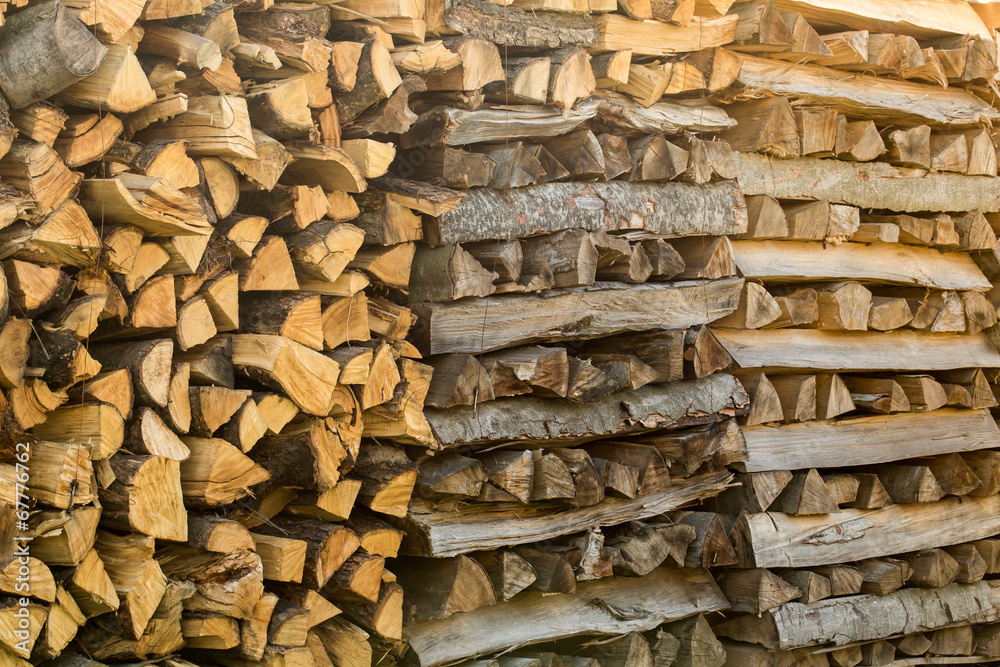 Pile of different chopped firewood prepared for winter Pile of different chopped firewood prepared for winter