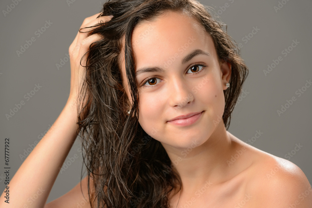 Fototapeta premium Teenage girl touch wet hair care cosmetics