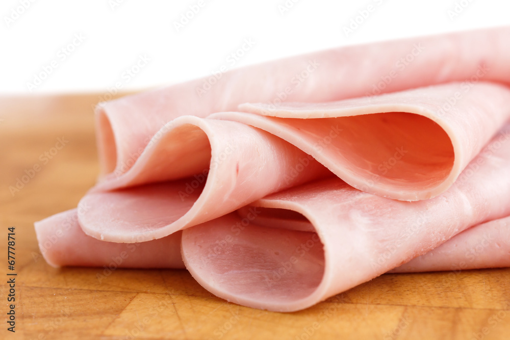Processed ham randomly arranged on chopping board. Processed ham randomly arranged on chopping board.