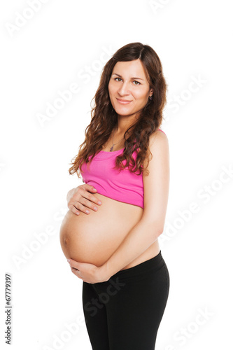 pregnant happy woman caressing her belly over white background