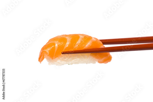 Sushi with Salmon is held by Chopsticks isolated on white