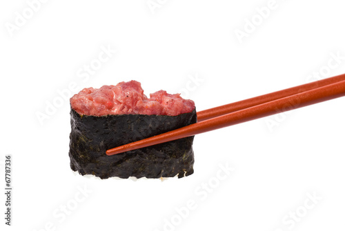 Gunkan Maki is held by Chopsticks isolated on white photo