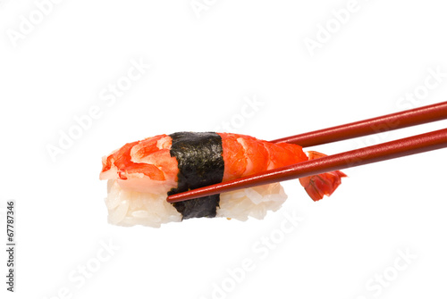 Sushi with Shrimp is held by Chopsticks isolated on white