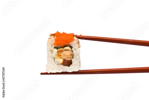 Sushi Roll is held by Chopsticks isolated on white