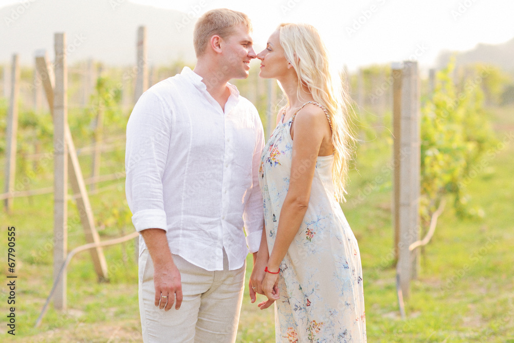 A young couple in love in the vineyards. Wedding day.