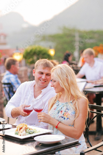 Beautiful couple eating at restaurant outside