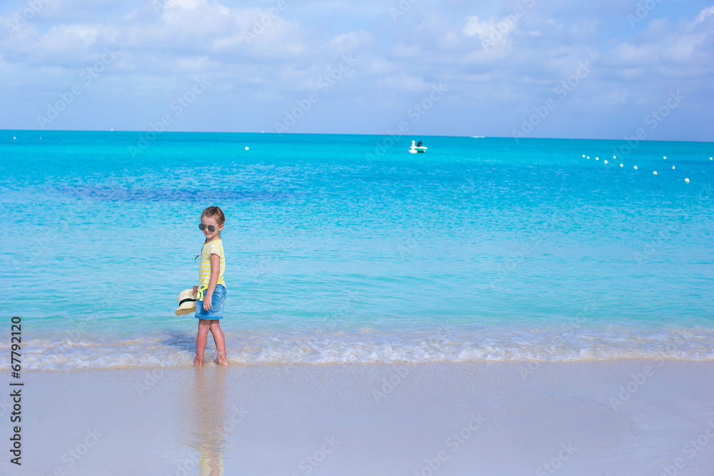 Little girl in sunglasses at beach during summer vacation Little girl in sunglasses at beach during summer vacation