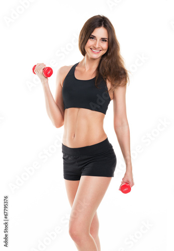 Beautiful slim woman with dumbbells on white