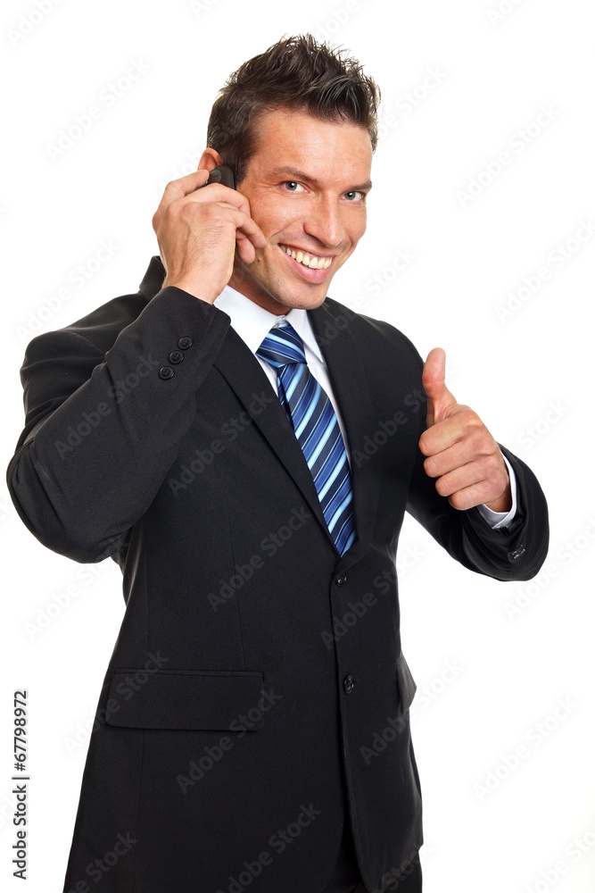 Handsome smiling man in suit talks into the mobile phone Handsome smiling man in suit talks into the mobile phone