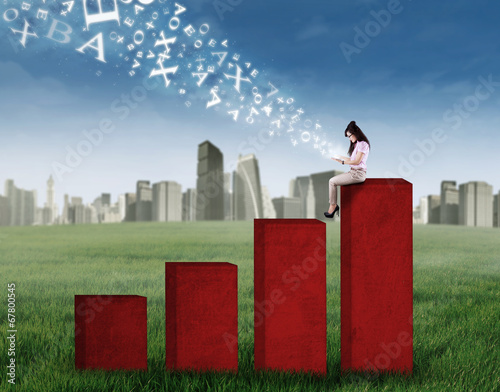 Woman using ditigal tablet on chart photo