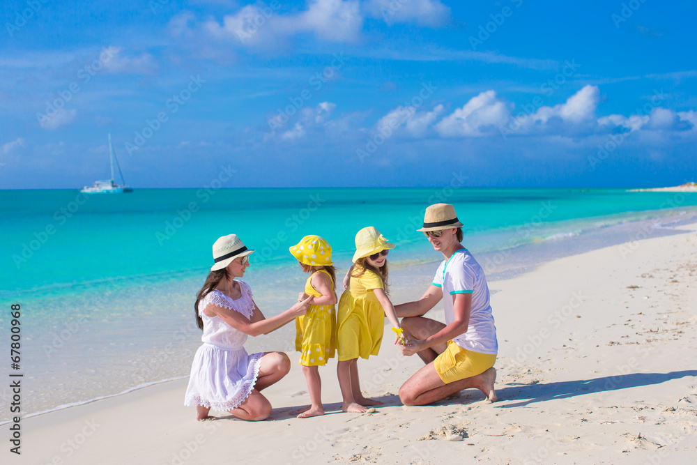 Young beautiful family with two kids on caribbean vacation