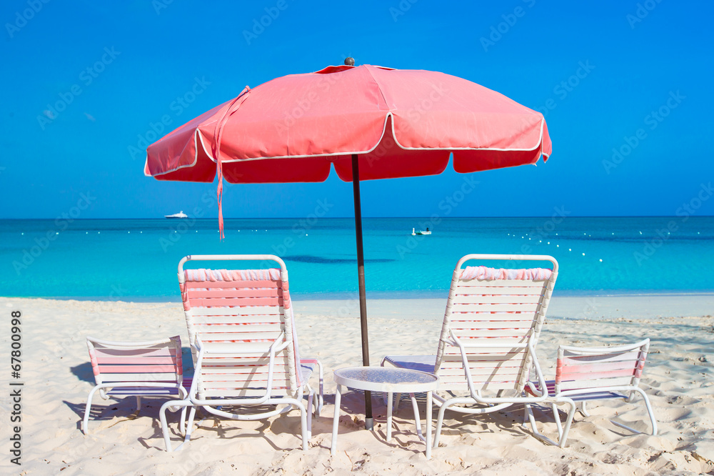 Cute umbrellas and sunbeds at tropical beach