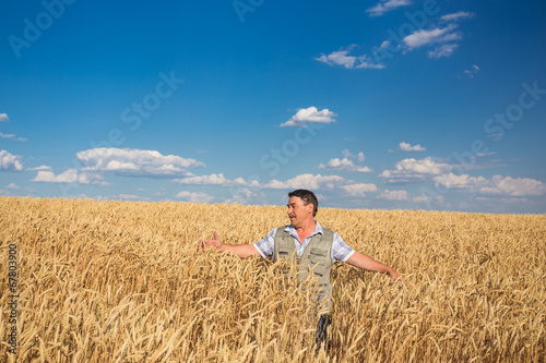 farmer standing in a wheat field © Ryzhkov Oleksandr