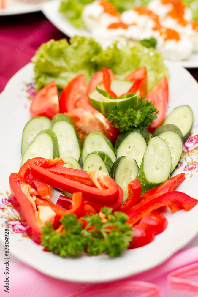 Plate of sliced vegetables isolated on white Plate of sliced vegetables isolated on white