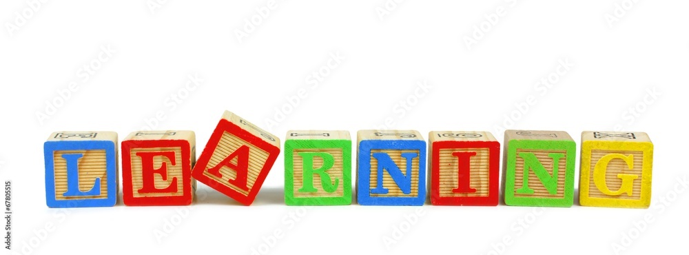 Toy wooden blocks spelling LEARNING isolated on white Toy wooden blocks spelling LEARNING isolated on white