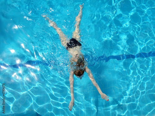 woman with swimsuit swimming on a blue water pool