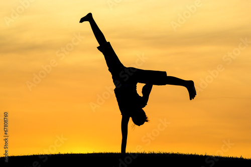 Cartwheel with one hand. photo