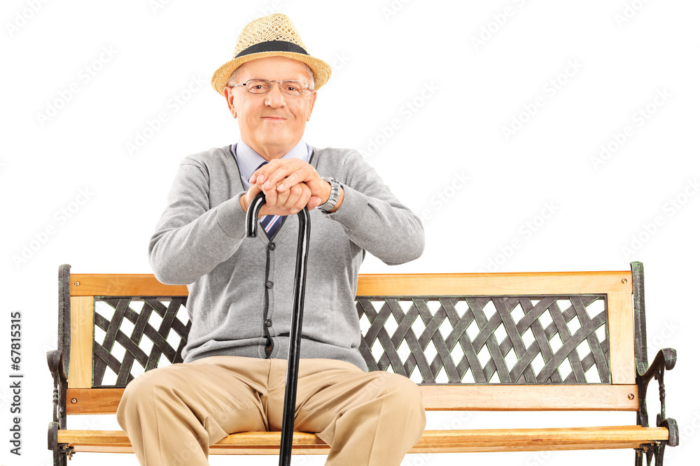Senior gentleman with a cane sitting on bench Senior gentleman with a cane sitting on bench