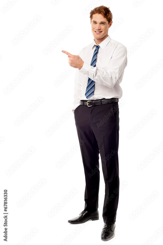 Young business executive pointing away Young business executive pointing away