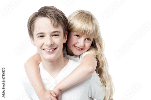 Young boy giving little girl piggyback ride