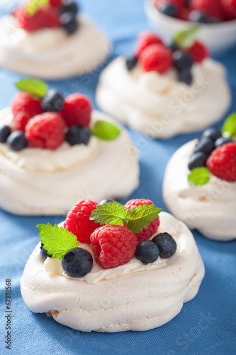 pavlova meringue cake with cream and berry